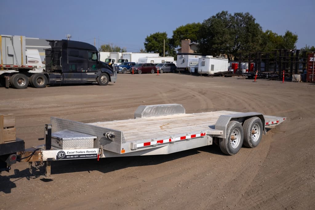 Flat deck trailer loaded with construction equipment Flat deck trailer loaded with construction equipment