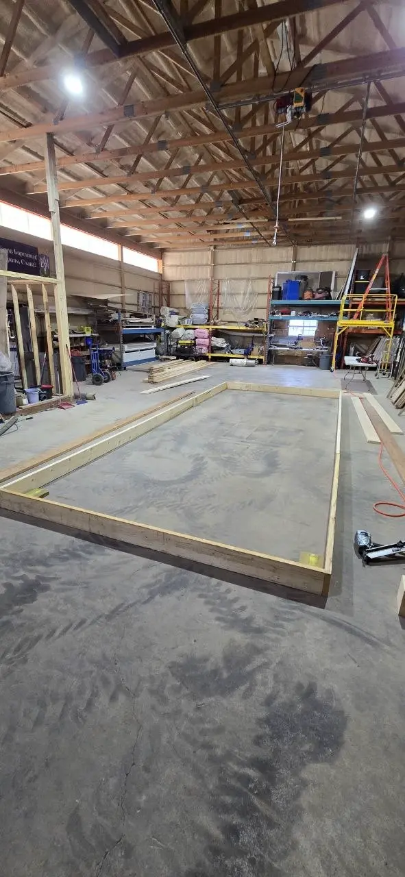 Wall plates laid out and squared on the shop floor for a new office trailer build